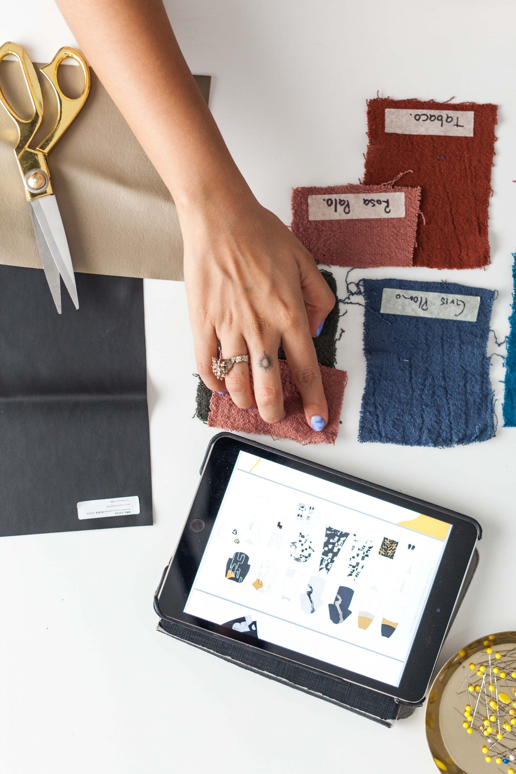 Fabric swatches and a tablet in a clothing design studio